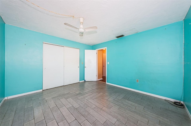 unfurnished bedroom with a closet and ceiling fan