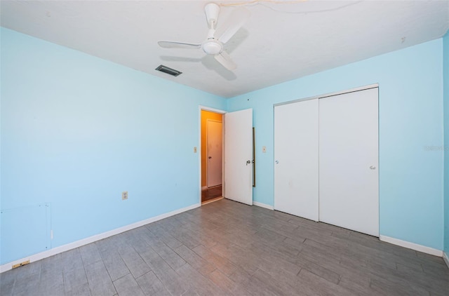 unfurnished bedroom with hardwood / wood-style flooring, a closet, and ceiling fan