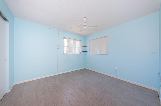 spare room with ceiling fan and hardwood / wood-style flooring