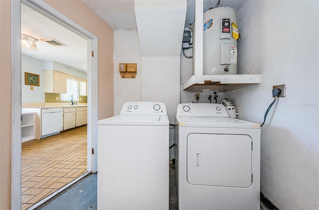 washroom featuring washing machine and clothes dryer, water heater, hookup for a washing machine, sink, and hookup for an electric dryer