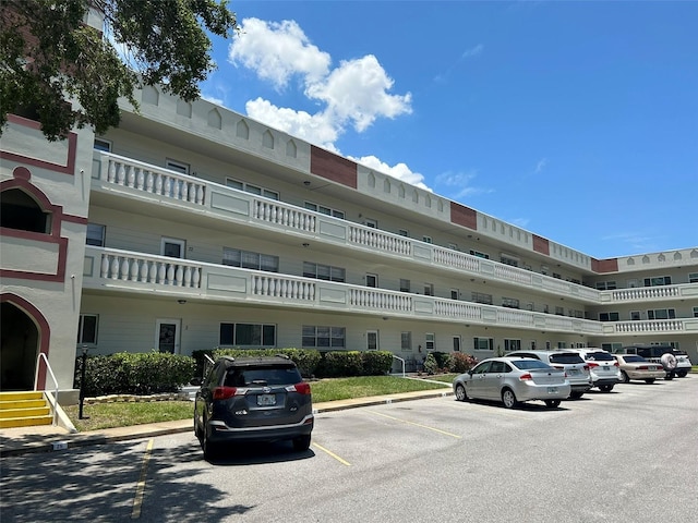 view of property featuring uncovered parking