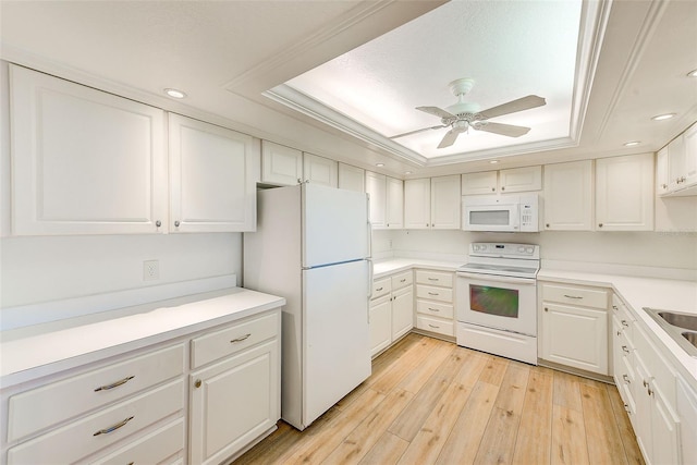 kitchen with white cabinets, ceiling fan, a raised ceiling, and white appliances