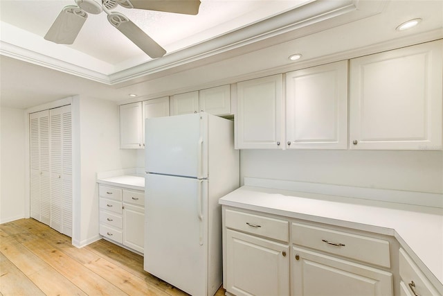 kitchen with white refrigerator, white cabinetry, and light hardwood / wood-style flooring