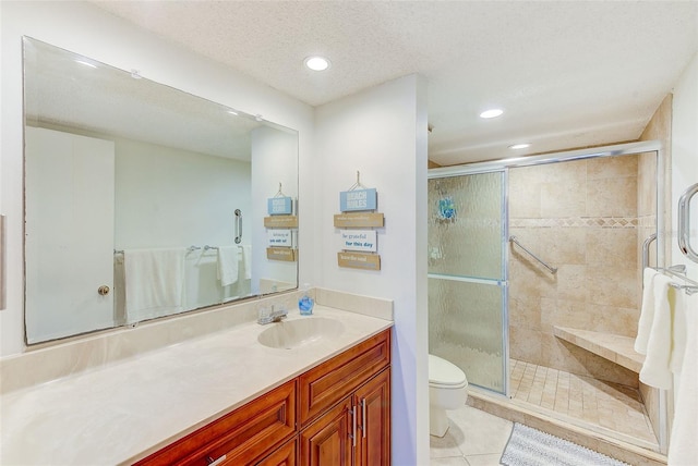 bathroom with an enclosed shower, vanity, a textured ceiling, tile patterned flooring, and toilet