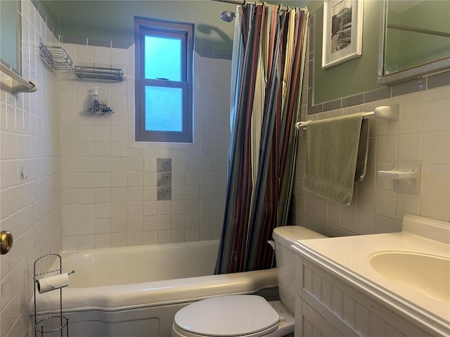 full bathroom with vanity, toilet, tile walls, and shower / tub combo with curtain