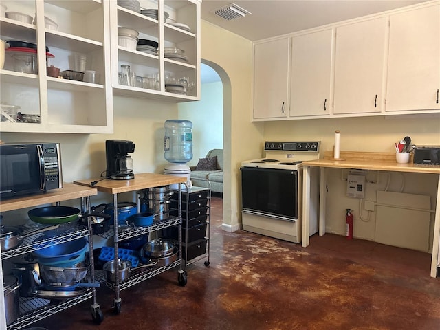 kitchen with electric stove and white cabinets