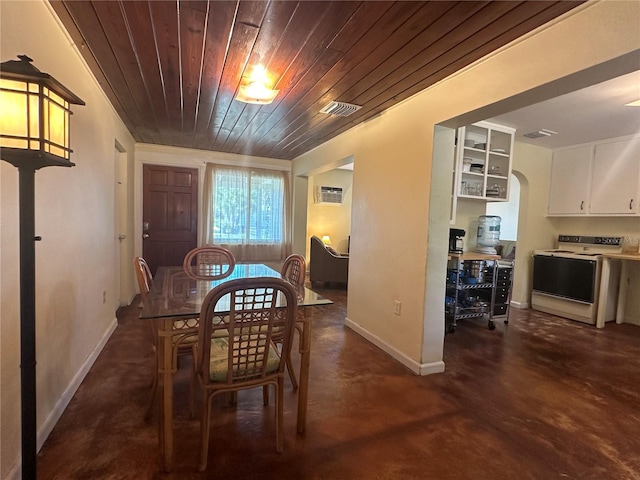 dining space with an AC wall unit and wooden ceiling