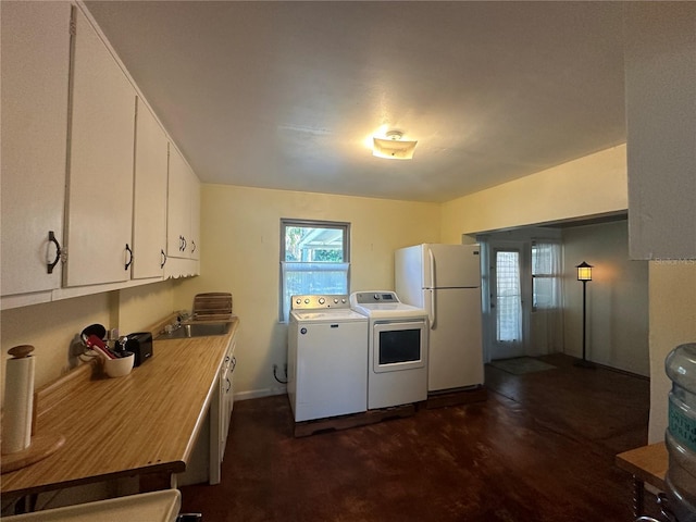 laundry room with independent washer and dryer and sink