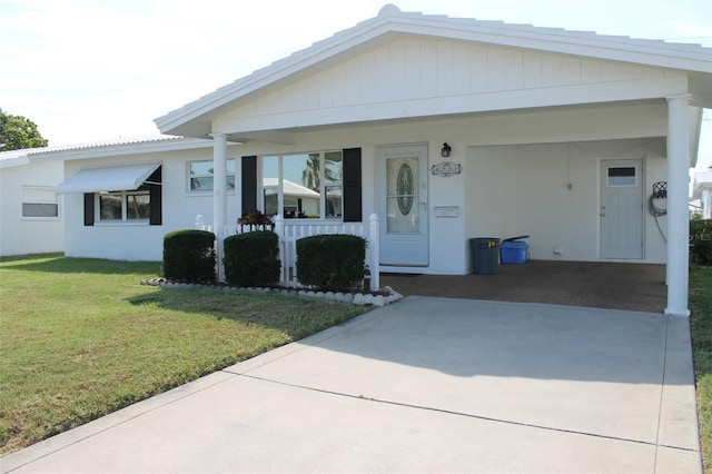 view of front facade with a carport and a front yard