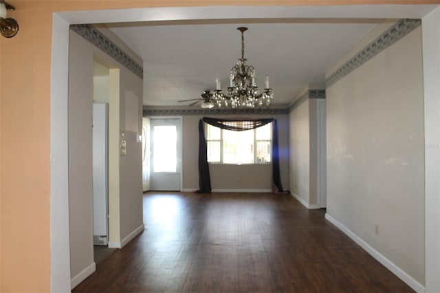 empty room featuring hardwood / wood-style flooring and ceiling fan with notable chandelier