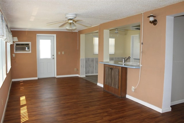 kitchen featuring ceiling fan, dark hardwood / wood-style flooring, sink, and a wall mounted AC