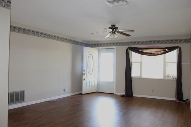 empty room with ceiling fan and dark hardwood / wood-style flooring