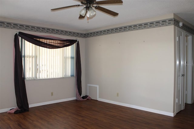 spare room with dark hardwood / wood-style floors and ceiling fan