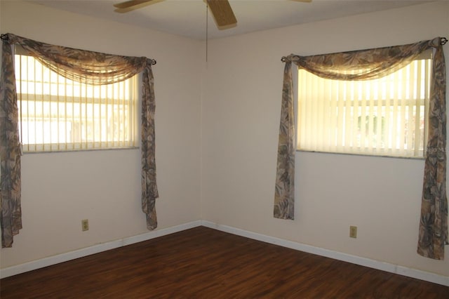 unfurnished room featuring dark hardwood / wood-style floors and ceiling fan