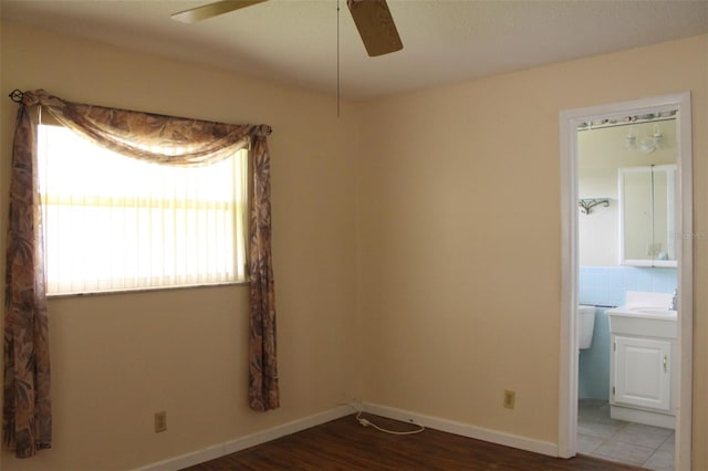 empty room featuring sink, hardwood / wood-style flooring, and ceiling fan