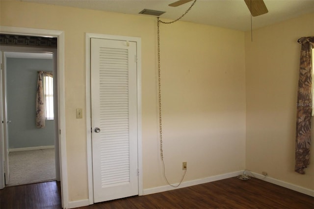 unfurnished bedroom with dark wood-type flooring and ceiling fan