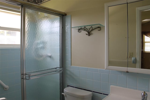 bathroom featuring tile walls and toilet