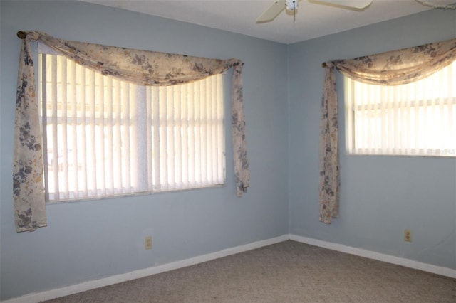 unfurnished room featuring plenty of natural light, ceiling fan, and carpet floors