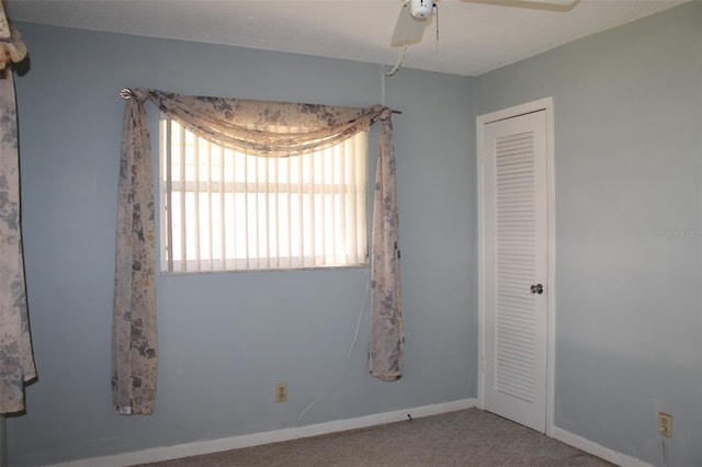 unfurnished room featuring carpet floors and ceiling fan