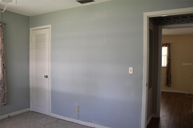 unfurnished bedroom featuring carpet and a closet