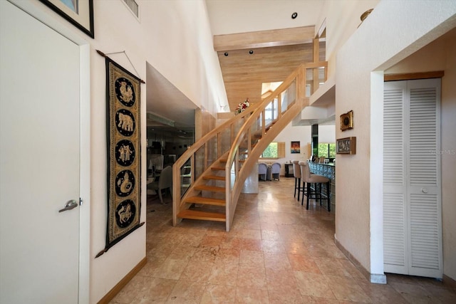 staircase with high vaulted ceiling