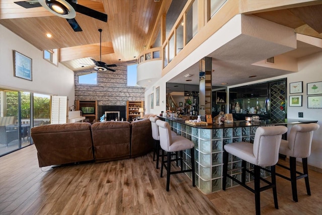 bar featuring hardwood / wood-style floors, high vaulted ceiling, ceiling fan, and wooden ceiling