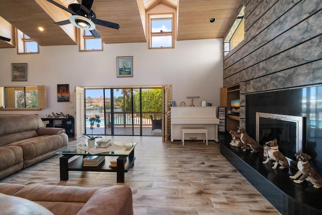 living room with ceiling fan, high vaulted ceiling, wooden ceiling, and hardwood / wood-style flooring