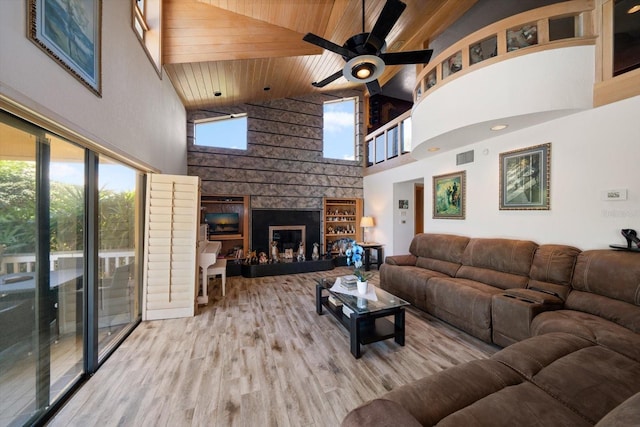 living room with a large fireplace, wooden ceiling, high vaulted ceiling, and light hardwood / wood-style flooring