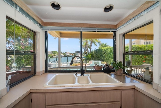 kitchen featuring sink and a water view