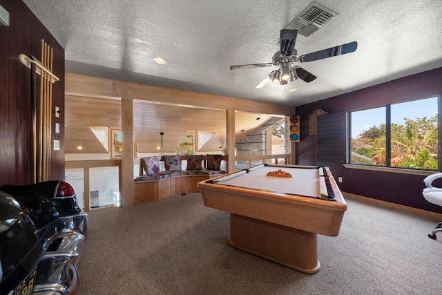 playroom with wood walls, carpet, a textured ceiling, and billiards