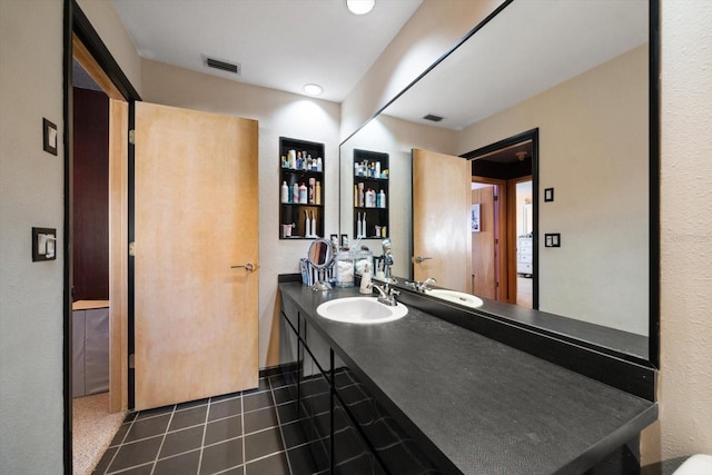 bathroom with tile patterned flooring and vanity