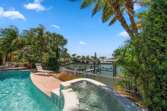 view of pool featuring a boat dock, a water view, and a patio area