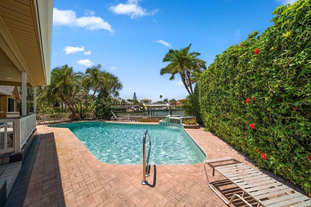 view of pool featuring a water view and a patio