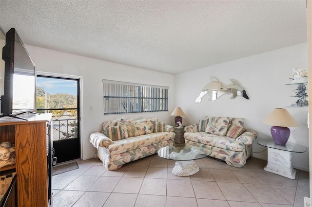 tiled living room featuring a textured ceiling