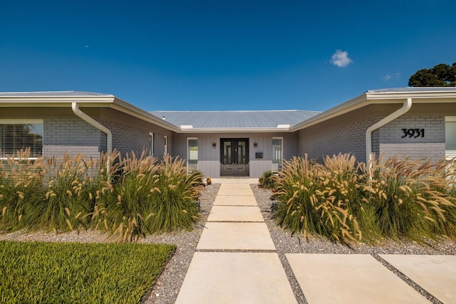 view of exterior entry featuring french doors