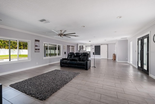 tiled living area with baseboards, visible vents, a ceiling fan, crown molding, and french doors