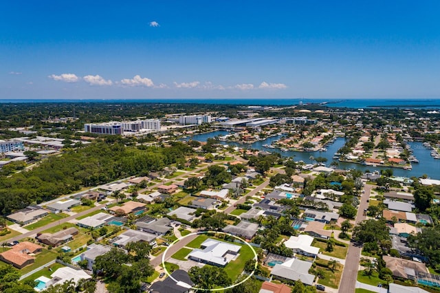 birds eye view of property with a water view and a residential view