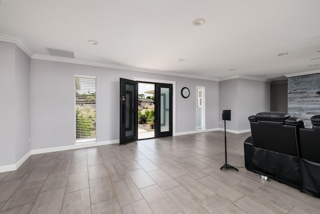 interior space featuring ornamental molding, wood finished floors, and baseboards