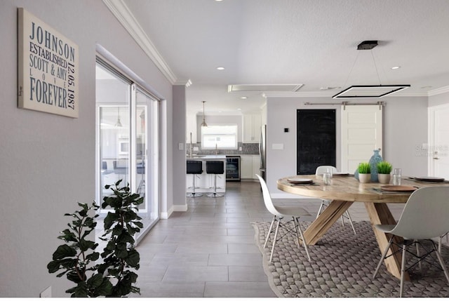 dining room featuring ornamental molding, wine cooler, and recessed lighting