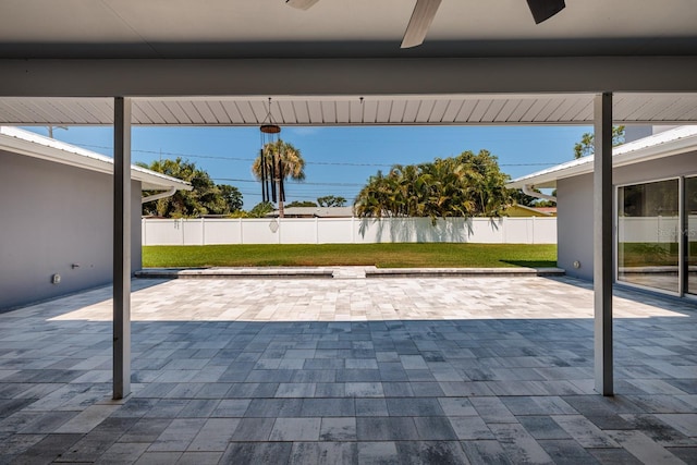 view of patio featuring fence and a ceiling fan