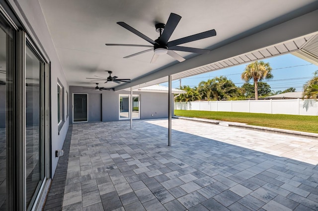 view of patio / terrace with ceiling fan and fence