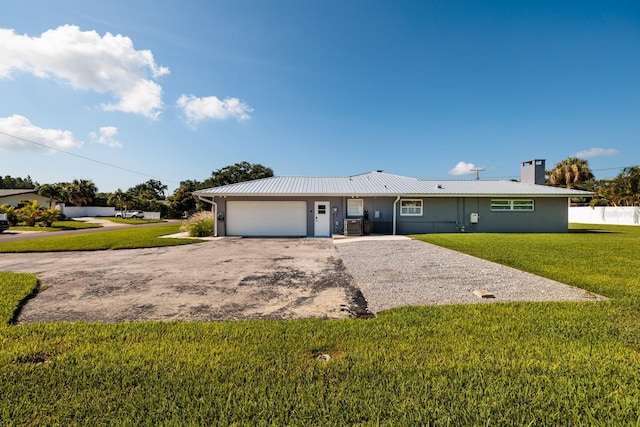 single story home featuring stucco siding, metal roof, a garage, driveway, and a front lawn