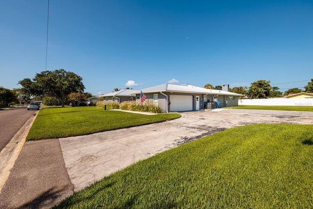 view of front of home featuring a garage, driveway, and a front lawn