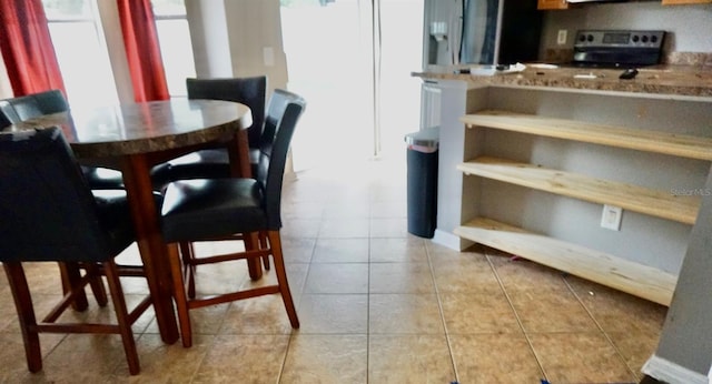 dining area featuring light tile patterned floors