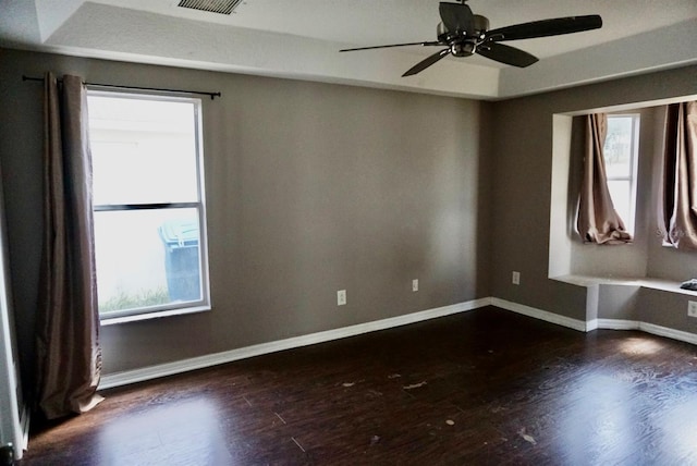 empty room with dark hardwood / wood-style floors and ceiling fan