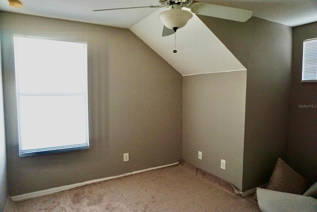 bonus room with ceiling fan, light colored carpet, and lofted ceiling