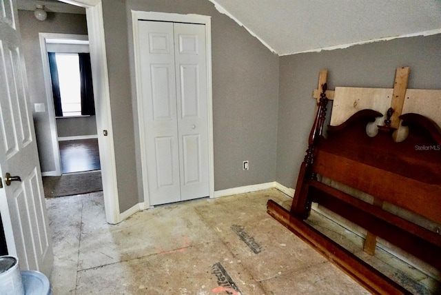 bedroom featuring a closet and lofted ceiling