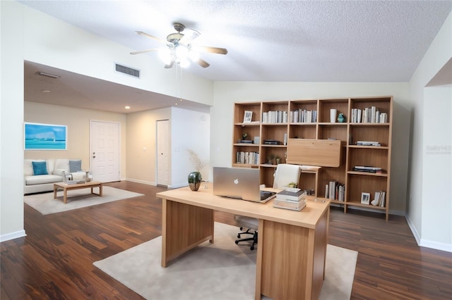 office featuring a textured ceiling, lofted ceiling, and dark wood-type flooring