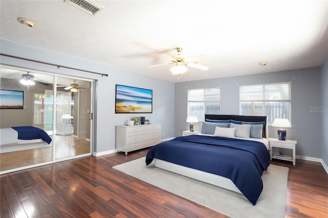 bedroom featuring access to outside, ceiling fan, and dark wood-type flooring