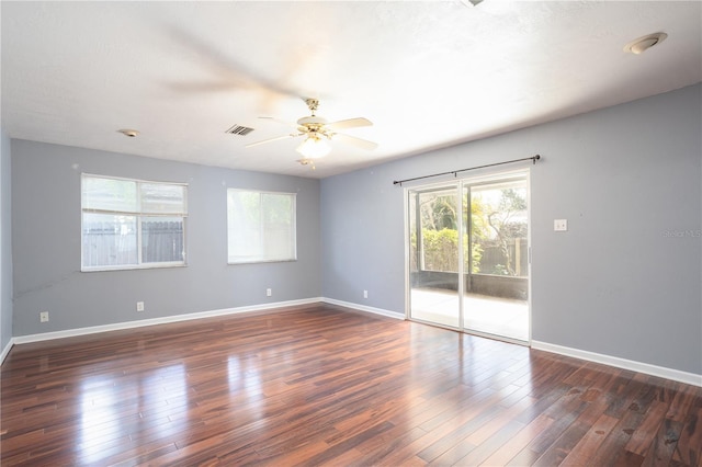 empty room featuring ceiling fan and dark wood-type flooring